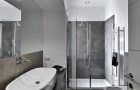 overview of modern bahtroom with glass shower cibicle and washbasin