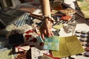 Woman picking out swatches from desk